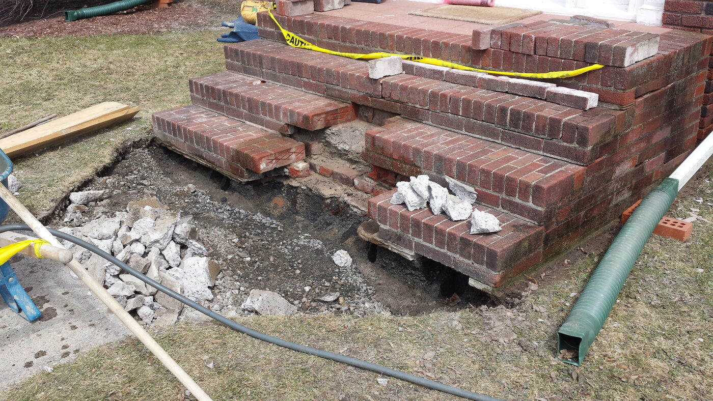 Brick chimney base being rebuilt down to a solid foundation