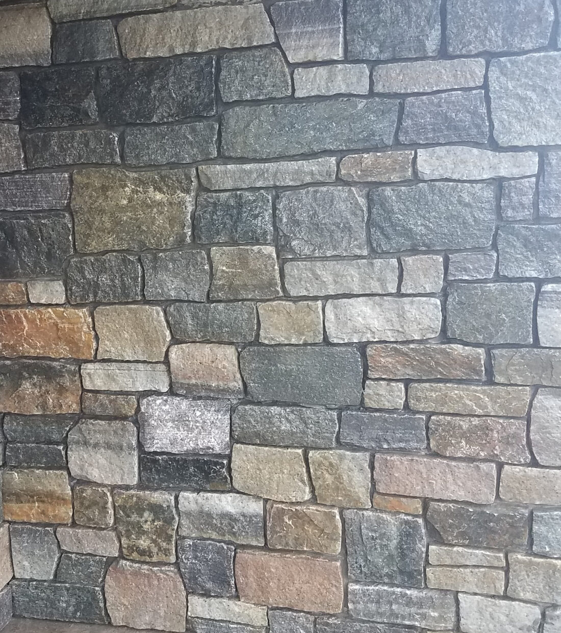 Close-up of hand-set cut-stone (ashlar) veneer with tight mortar joints